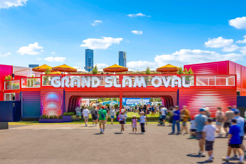 Fans entering the Grand Slam Oval through an arch with an outdoor dining area above. Groblox modular buildings used to create an Event space.