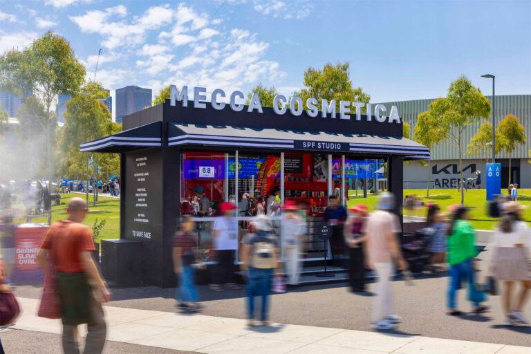 a group of people walking in front of a small black building